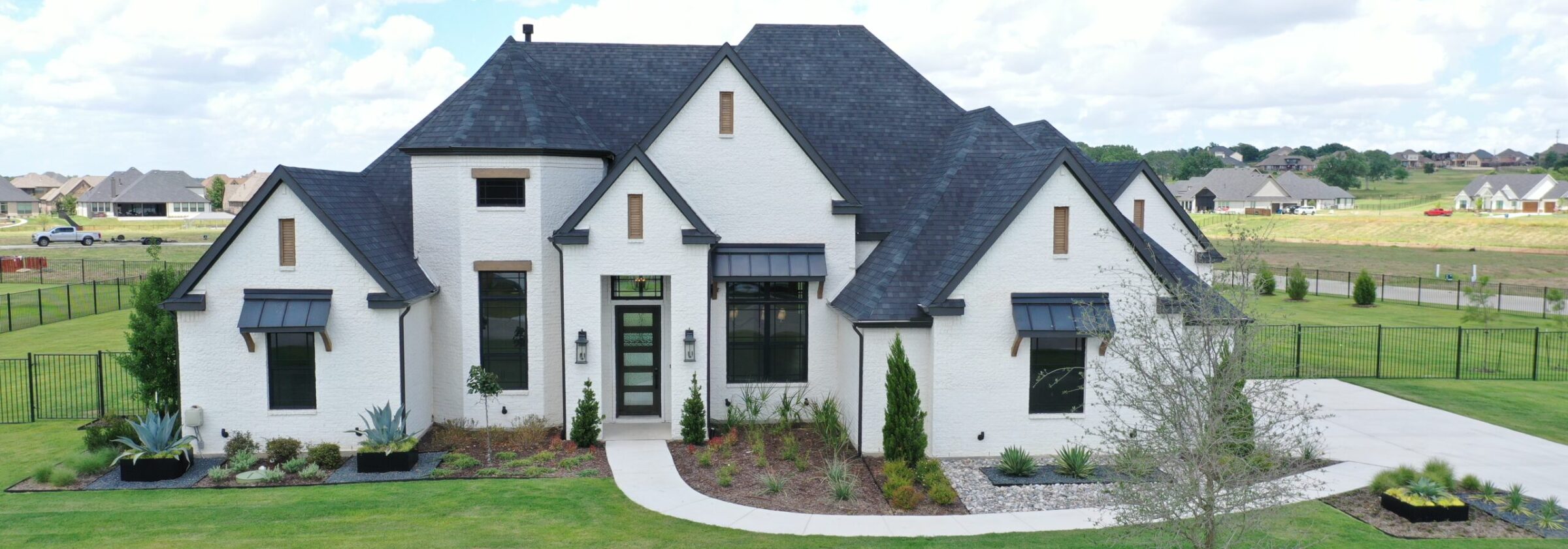 Home inspector examining brick foundation of Southlake TX house with clipboard